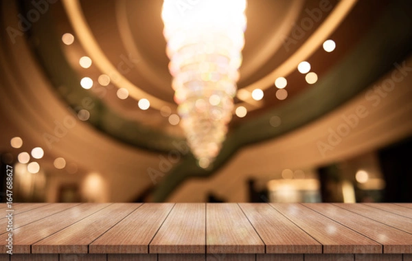 Fototapeta Empty wooden table top with lights bokeh on blur restaurant background.