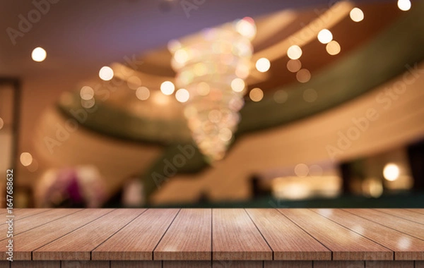 Fototapeta Empty wooden table top with lights bokeh on blur restaurant background.