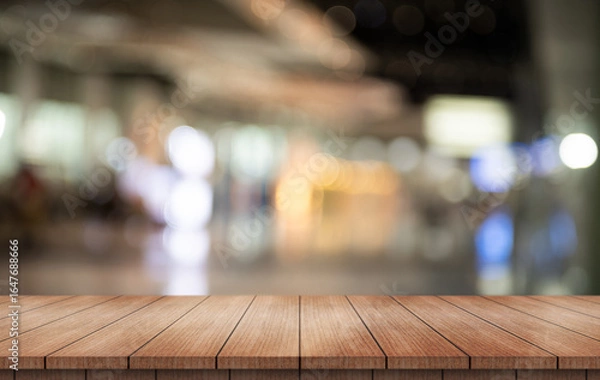Fototapeta Empty wooden table top with lights bokeh on blur restaurant background.