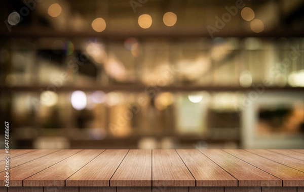 Fototapeta Empty wooden table top with lights bokeh on blur restaurant background.