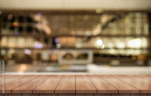 Fototapeta Empty wooden table top with lights bokeh on blur restaurant background.
