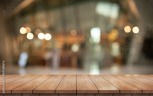 Fototapeta Empty wooden table top with lights bokeh on blur restaurant background.
