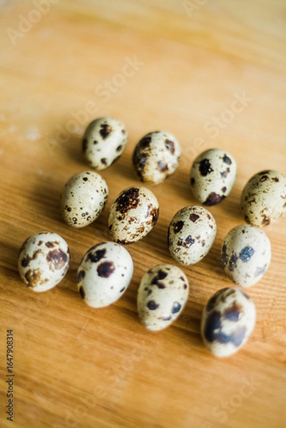 Obraz Fresh raw quail eggs on wooden table.