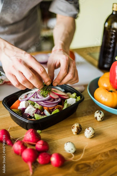 Obraz Hands cutting onion and radish for fresh vegetable salad.