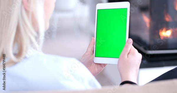 Fototapeta woman on sofa using tablet computer