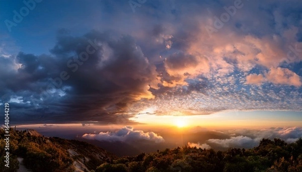 Fototapeta dramatic sunset sky panorama during golden hour cloud scape serene sky path above raising clouds at sunset