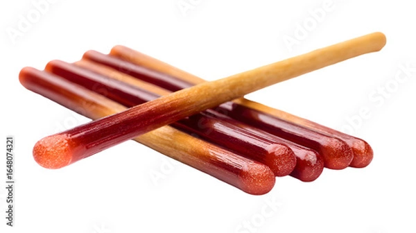 Fototapeta A close up of several pocky sticks with chocolate covered ends laying on a black surface in a pile