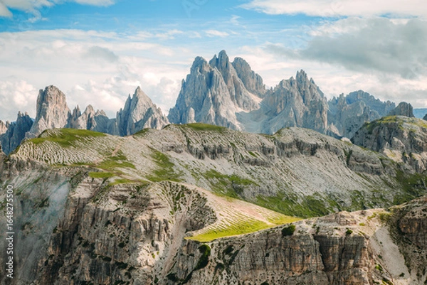 Fototapeta Grassy Slope at Tre Cime di Lavaredo Peaks under Partly Cloudy Sky