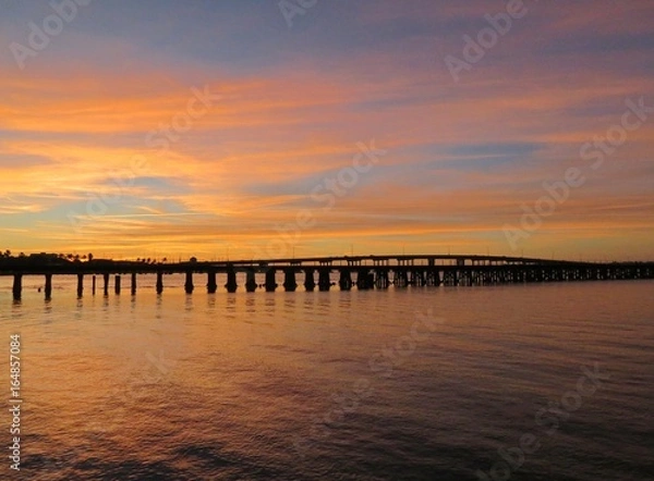Fototapeta Sun setting at River walk along the Manatee River in Bradenton Florida