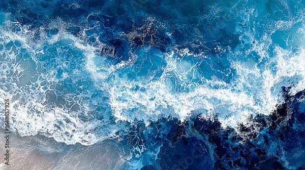 Fototapeta Aerial view of vibrant ocean waves crashing onto a sandy beach under bright sunlight