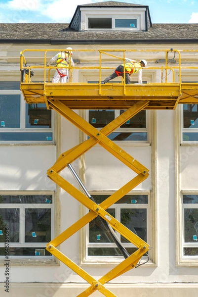 Obraz Pintores pintando la fachada de un edificio.