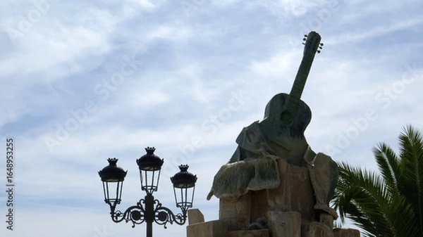 Obraz Guitar Fountain against cloudy sky