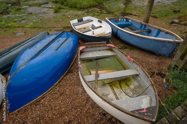 Fototapeta Small boats at the quay on the River Deben in the historic town of Woodbridge in Suffolk, UK.
