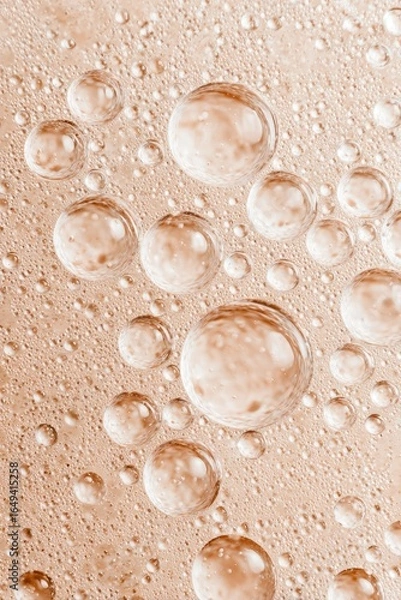 Fototapeta Close-up of  water droplets on a pale peach surface