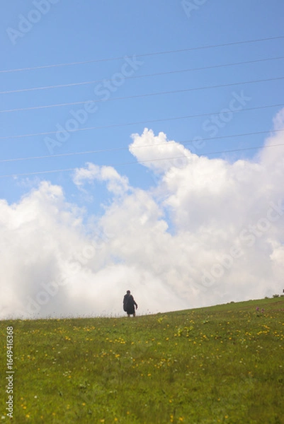 Fototapeta One tourist against the backdrop of mountains and clouds in Gomismta, Guria, Georgia