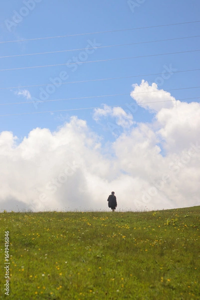 Fototapeta One tourist against the backdrop of mountains and clouds in Gomismta, Guria, Georgia