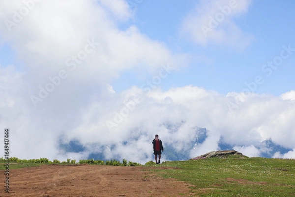 Fototapeta One tourist against the backdrop of mountains and clouds in Gomismta, Guria, Georgia