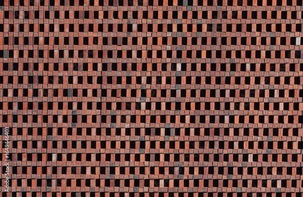 Fototapeta Red brick wall with geometric ventilation pattern