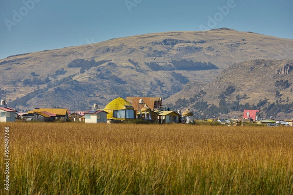 Fototapeta The Uros Islands are a group of artificial floating islands located on Lake Titicaca, which is situated on the border of Peru and Bolivia. The islands are home to the Uros people. Puno Peru