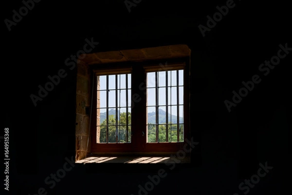 Fototapeta A window with a view towards the foot-hills of the Pyrenees Mountains in the town of Espelette, France.