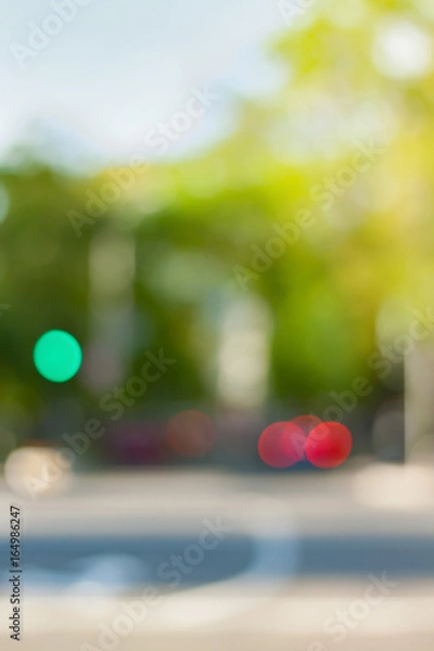 Fototapeta Vertical background photo.Cityscape bokeh. Defocused abstract city.Background out of focus.Can use as wallpaper,design. Summer blurry city backdrop.Travel out of focus photos. Fairy defocused photos
