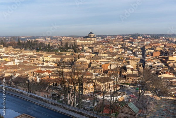 Fototapeta Cityscape panorama Toledo Spain: Capture a sweeping view of a historical city on a clear day, showcasing the unique architecture and cultural heritage of the region.