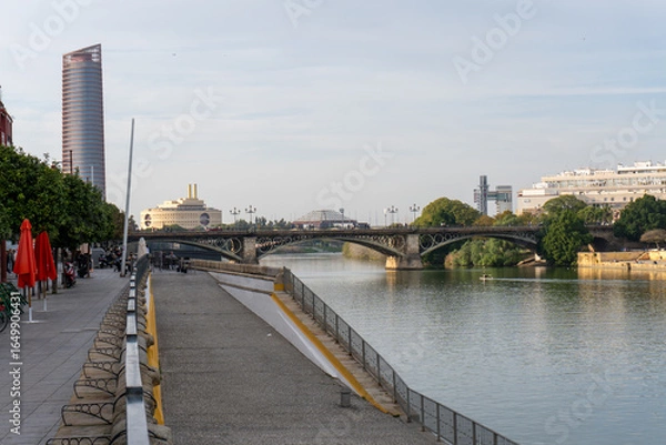Obraz Seville's Waterfront Bridge: Captured from the riverbank, this photo showcases the bridge's elegant architecture as it gracefully spans across the tranquil river.