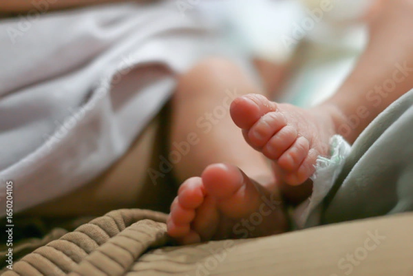 Obraz Small foot of infant during sleeping in bed room.