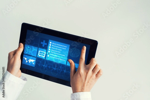 Obraz Close of female doctor hands working with tablet pc computer