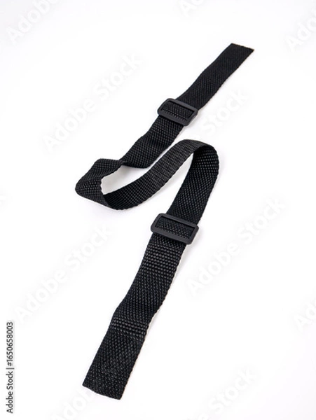 Obraz Black strap lies in a zigzag pattern on a white background