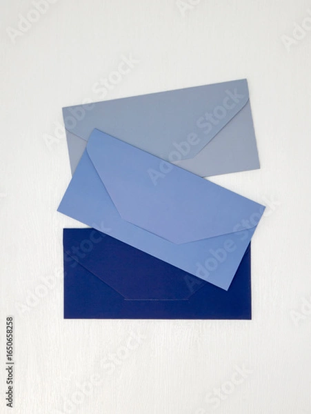 Obraz Blue and light blue envelopes lie on white background, message concept