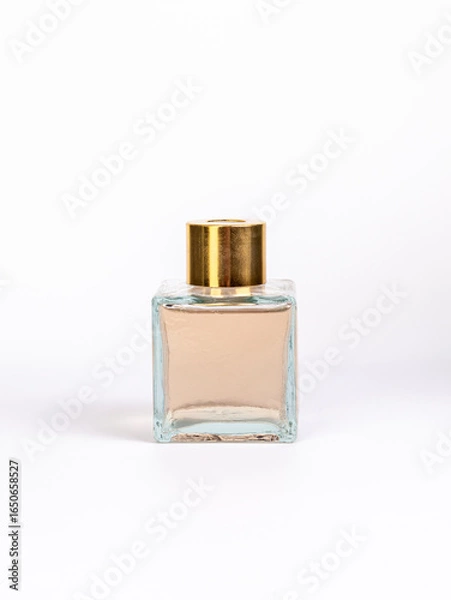 Obraz Diffuser for home. Bottle with brown transparent liquid on white background