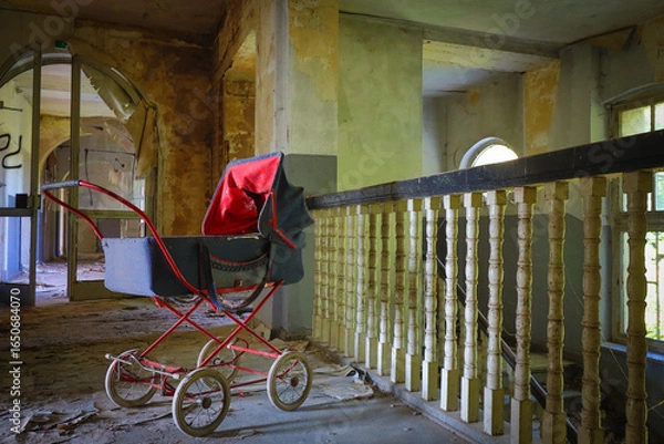 Fototapeta old retro stroller in an abandoned children's home