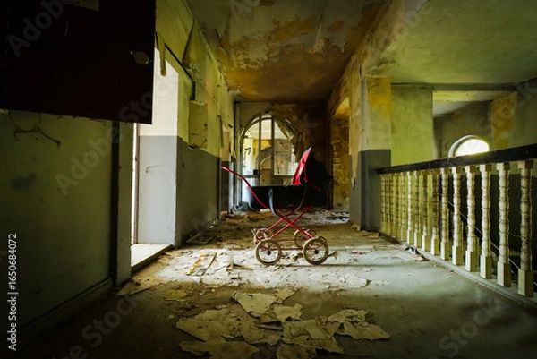 Fototapeta old retro stroller in an abandoned children's home