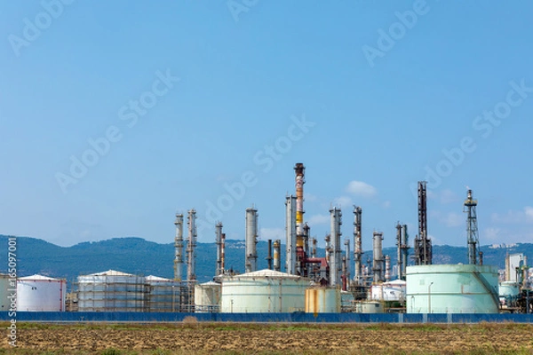 Obraz Industrial refinery plant with mountain in the background