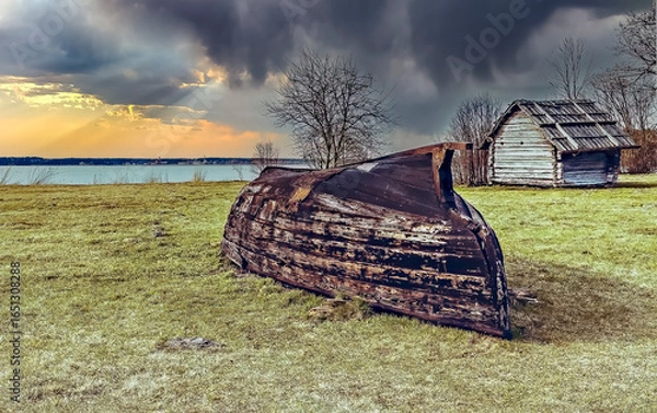Obraz Old fishing boat in the field near a lake in autumn