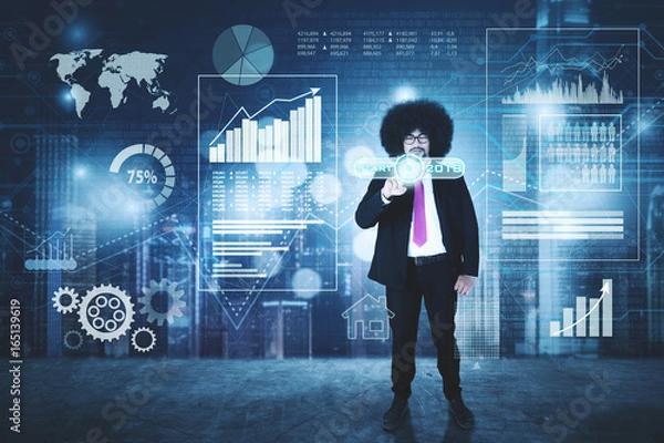 Fototapeta Businessman touching a virtual start button