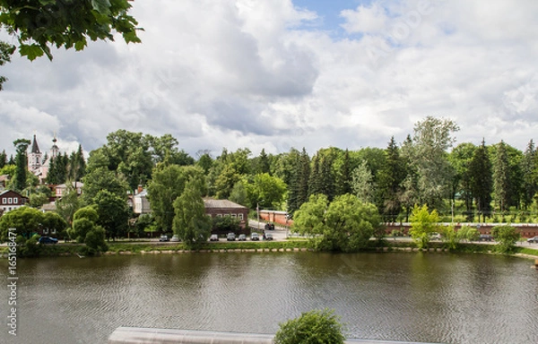 Obraz The ancient city of Sergiev-Passad. Lake in the center of the city. Architecture of the century before last. The city is drowning in greenery. View of the city and the lake from the mountain.