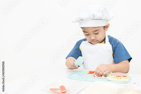 Obraz The boy is studying cooking.