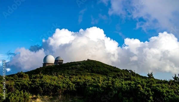 Fototapeta Hilltop radar domes under a vibrant sky