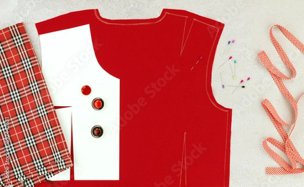 Fototapeta The panorama shows the modeling of clothes and the sewing process. Red fabric, a drawing of the base of the front and back, a measuring tape and buttons for sewing a dress.