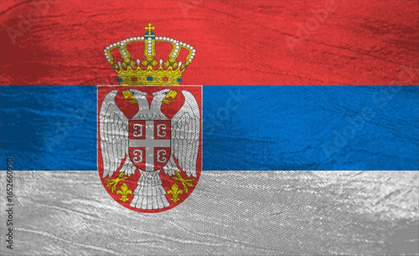 Fototapeta Serbia's vibrant flag waving under bright sunlight in the open sky