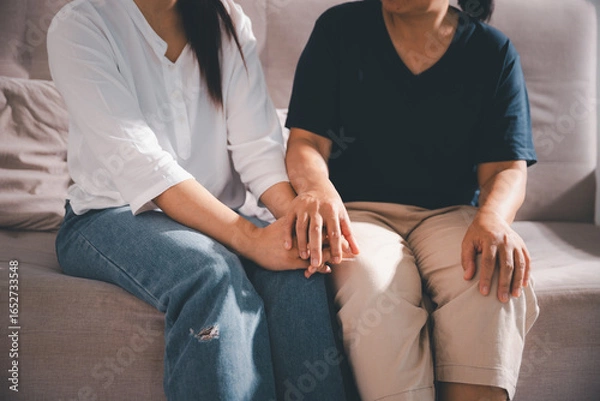 Fototapeta Moment of deep grief, sorrow and anxiety, lonely person overwhelmed by despair feels spark of hope when helping hand reaches out with genuine emotion to ease their problem.
