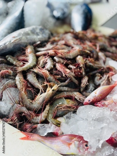 Fototapeta Fresh chemmeen (prawns) displayed in a local seafood shop, showcasing natural texture and market atmosphere, perfect for themes of seafood, cooking, fishing, and local trade.