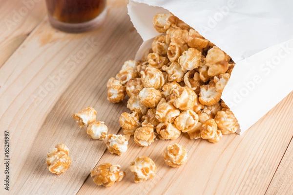 Obraz Popcorn in bag on table.