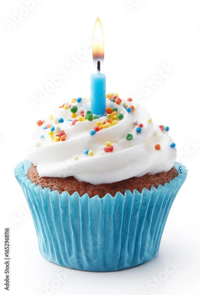 Fototapeta A cupcake with a blue paper case, white frosting, and colorful sprinkles,