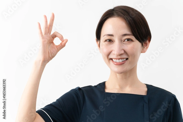 Fototapeta エステサロン制服を着た若い女性　ビューティイメージ