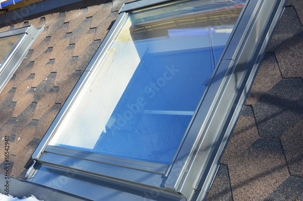 Fototapeta Roof windows and skylights installation with snow in winter.