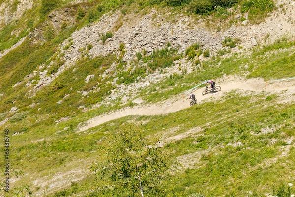 Fototapeta A father and son practicing downhill mountain biking in Verbier, Switzerland