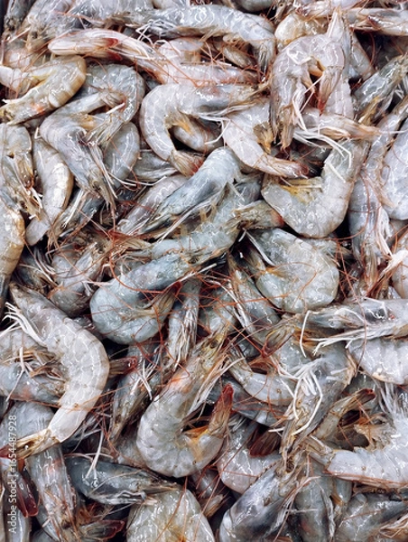 Fototapeta Prawns at wet market seafood area, common ingredient across the world, particularly common in Asian cuisine, full of prawns with ice, top view of market tray